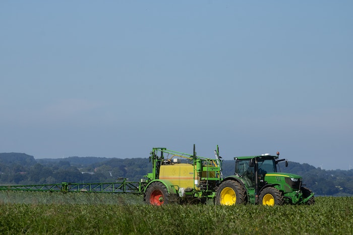 Tractor spraying a field