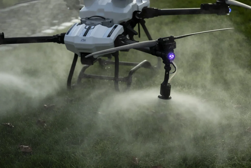 Drone spraying over a field