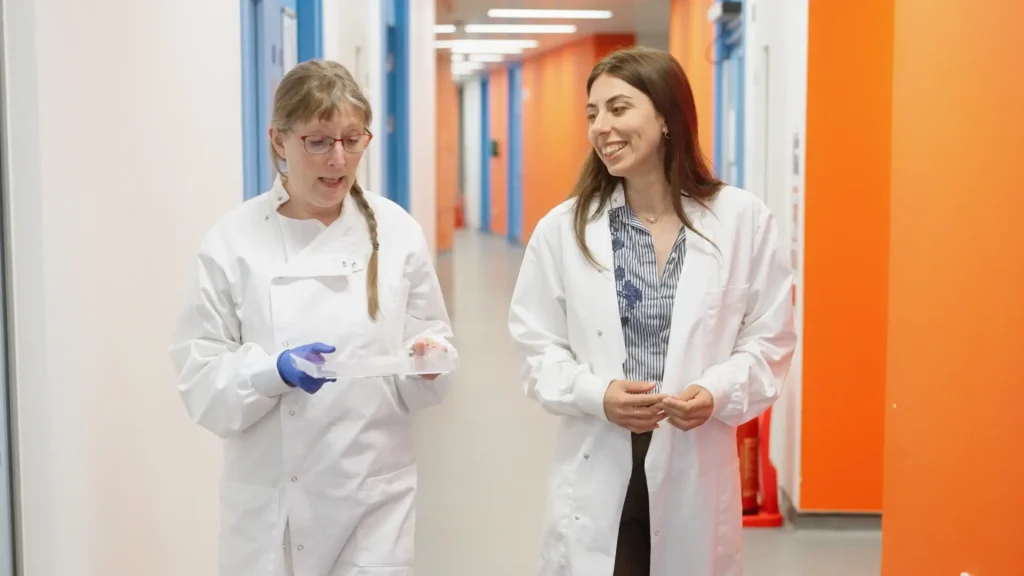 CDotBio scientists Dr Veronica Greco and Dr Fran Robson walking through the lab while discussing sugar-based nanotechnology for crop protection.