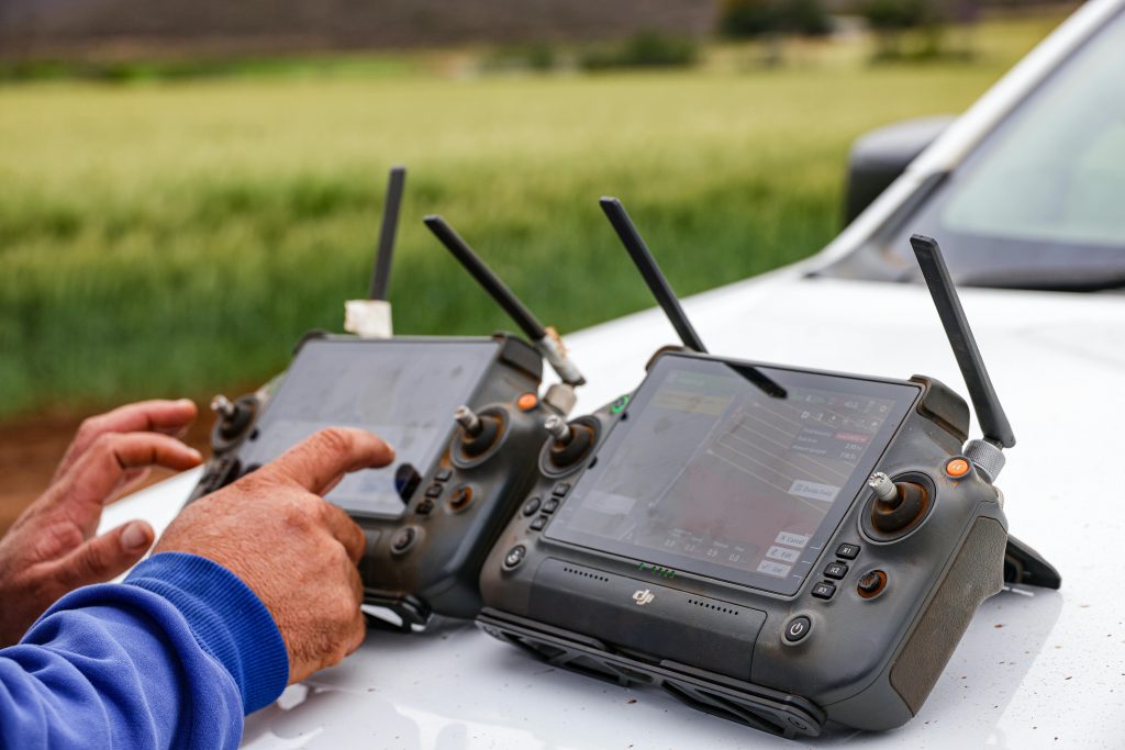 Farmer with drone controls